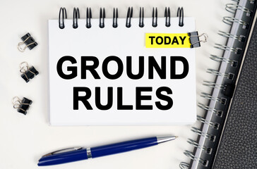 On the table is a pen and a notebook with inscriptions - Today and GROUND RULES