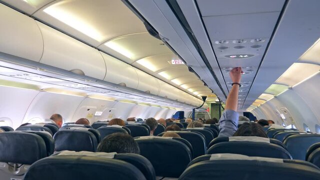 Airplane interior with people sitting during the flight. Travel concept
