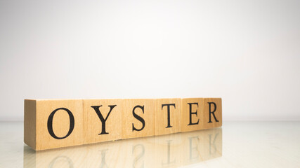The name Oyster was created from wooden letter cubes. Seafood and food.