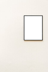 an empty frame on the background of a textured beige wall