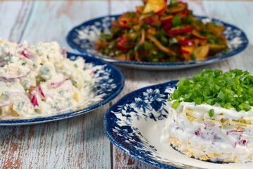 Three Delicious and fresh salads on a plates made of healthy products cooked at home for home party. close up
