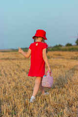 
A little girl hurries to her grandmother through a golden wheat field