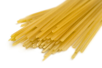 dry commercial straight spaghetti noodles on white background
