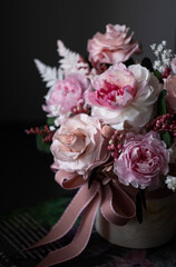 Beautiful bouquet of pink roses on a dark background, soft and romantic. Still life with a flowers. Still life with a bouquet.