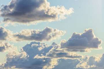 blue clouds with sun large clouds background
