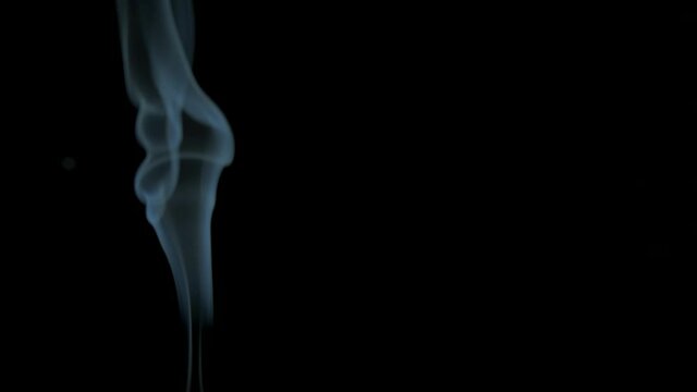 Vapor of smoke in the room. A view of white vapor of smoke on the black background.