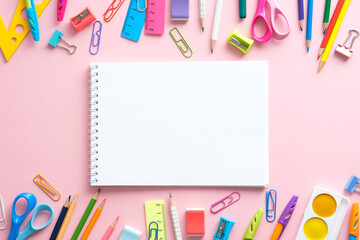 School supplies and blank paper notepad on pink background. Back to school concept, Top view, flat lay,