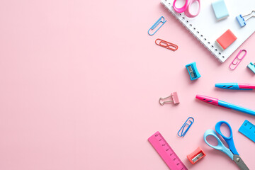 School stationery on pink background. Minimal style. Back to school concept. Flat lay, top view, overhead.