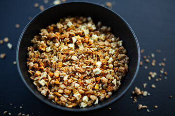 Homemade granola in bowl on dark