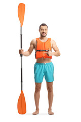 Full length portrait of a young man with a life jacket and a paddle pointing