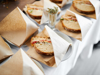 French sandwich in paper at a buffet table