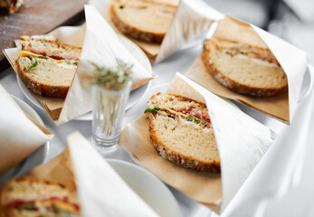French sandwich in paper at a buffet table