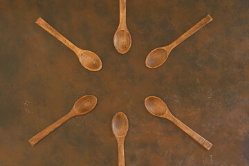 old empty spoons on wooden background