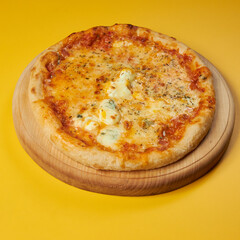 rustic pizza margarita on wooden board and yellow background