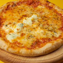 rustic pizza margarita on wooden board and yellow background
