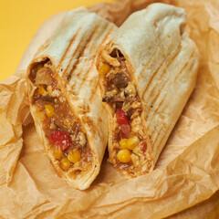 mexican burrito on craft paper and yellow background