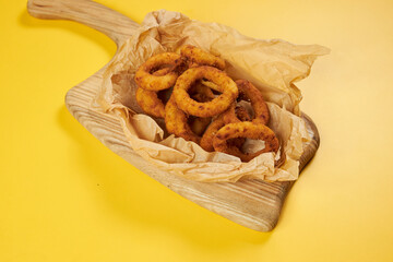 onion rings on craft paper and yellow background