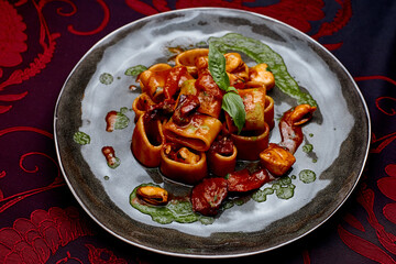 beautifully served Conchiglioni with tomatoes and herbs
