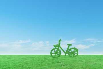 Fototapeta na wymiar Green ecological bicycle on grass field and blue sky background. Environmentally friendly concept