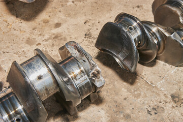 Fractured Crankshaft with Engine Oil Stain of Truck Engine on Concrete Floor