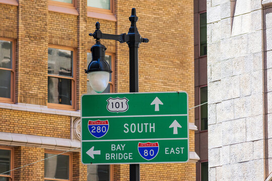 Interstate 101, 280 and 80 highway road sign showing drivers the directions to highways and Bay Bridge in Financial District of downtown San Francisco, California - Powered by Adobe