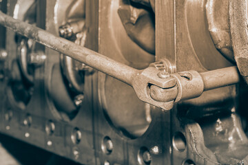 Black and White Car Mechanic or Auto Mechanic Use Breaker Bar Loosen Bolt of Crankshaft of Truck...
