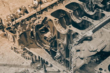 Black and White Cylinder Block and Cylinder Head and Crankshaft and Bolt on Concrete Floor