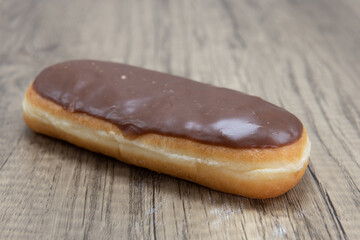 Chocolate bar donut is textured with glazed coating for a sweet treat delight
