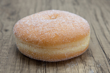 Sugar raised round donut is textured with sugar coating for a sweet treat delight