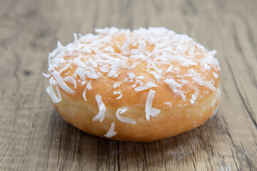 Cocnut raised  donut is textured with glazed coating for a sweet treat delight