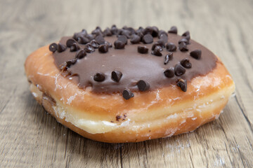 Chocolate chip bar donut is textured with sprinkled chip coating for a sweet treat delight