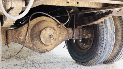 Old rear axle truck. Dirty truck sprockets with attachments and worn wheels. Select the focus close...