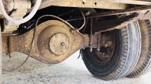 Old rear axle truck. Dirty truck sprockets with attachments and worn wheels. Select the focus close to the subject.