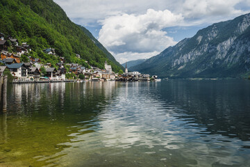 Fototapeta premium Scenic view of famous Hallstatt lakeside town reflecting in Hallstattersee lake in the Austrian Alps. Salzkammergut region, Austria