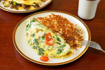 Asparagus omelette with cheese and spinach and hash browns