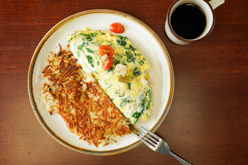 Asparagus omelette with cheese and spinach and hash browns