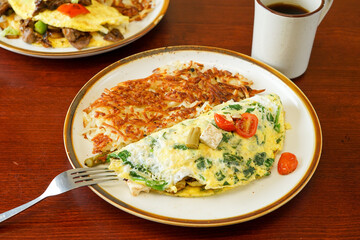 Asparagus omelette with cheese and spinach and hash browns