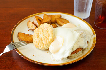 Fried eggs, biscuit and potatoes