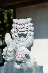 statue of guardian lion-dogs at suzuka shinto shrine in kagnagawa, japan