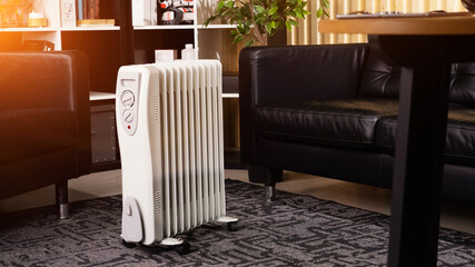Oil-filled electrical mobile radiator heater for home - obrazy, fototapety, plakaty