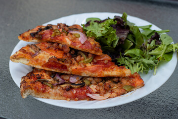 Deluxe Pepperoni Pizza with Mozzarella cheese, salami, Tomatoes, pepper, Spices and Fresh Basil