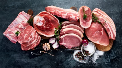 Fotobehang Different types of raw meat on black background © bit24