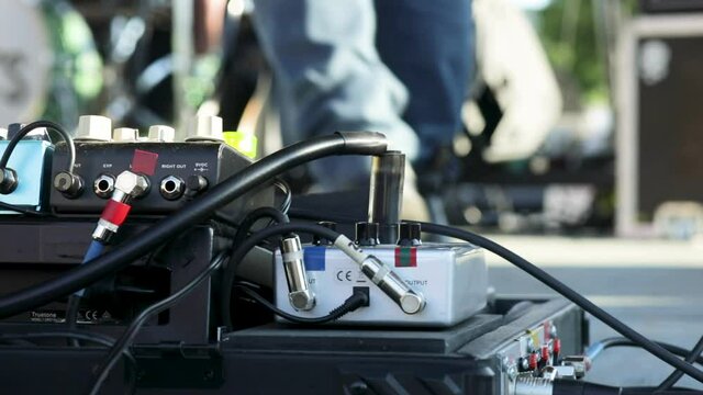 Guitarist Switching Pedalboard During An Outdoor Concert At Daytime. - Close Up Shot