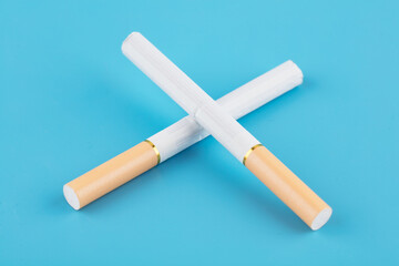 Two cigarettes on blue background