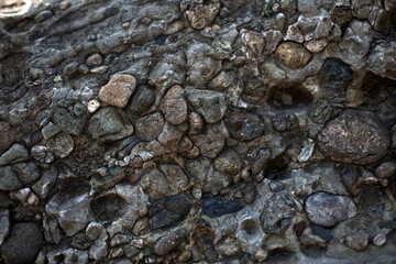 background gray material, old stones, rock near the ocean
