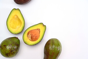 Fresh whole, half and sliced avocado on white background.Healthy fruits concept.