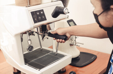 hand holding coffee machine in coffee shop. coffee shop concept