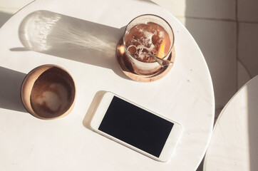 coffee, phone and squash on the coffee shop table