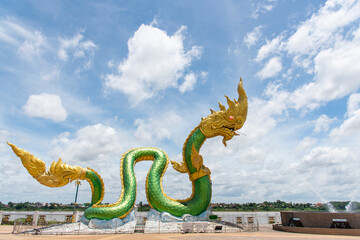 Full body Naga statue, with beuatiful sky background at the mekong river, Wat Lamduan temple, Nong Khai province Thailand. Most famous landmark. Left side © KAVIN