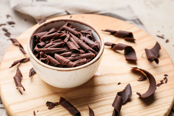 Bowl with delicious chocolate curls on table
